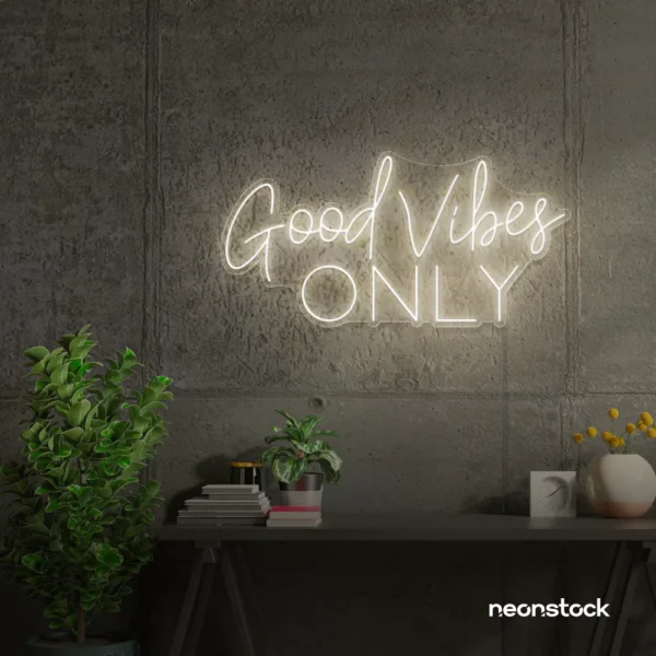 White neon sign spelling Good Vibes Only on a concrete wall.