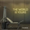 The World Is Yours neon sign in warm white for empowerment decor, teen rooms, and motivational walls.