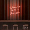 Welcome to the Jungle neon sign in peachy pink for bold interiors, gaming setups, and tropical decor.