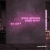 When Nothing Goes Right Go Left neon sign in baby pink for motivational spaces and creative rooms.