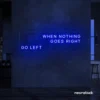 When Nothing Goes Right Go Left neon sign in dark blue for motivational spaces and creative rooms.