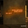 When Nothing Goes Right Go Left neon sign in orange for motivational spaces and creative rooms.