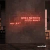 When Nothing Goes Right Go Left neon sign in peachy pink for motivational spaces and creative rooms.