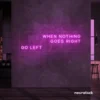 When Nothing Goes Right Go Left neon sign in pink for motivational spaces and creative rooms.