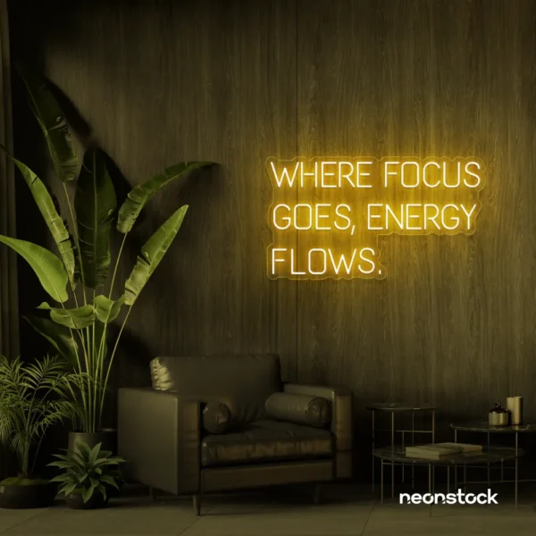 Where Focus Goes Energy Flows neon sign in golden yellow for productivity decor and creative inspiration.