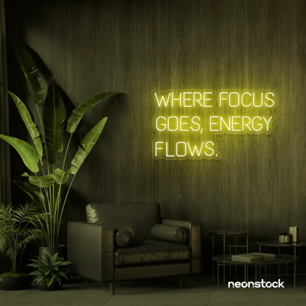 Where Focus Goes Energy Flows neon sign in lemon yellow for productivity decor and creative inspiration.
