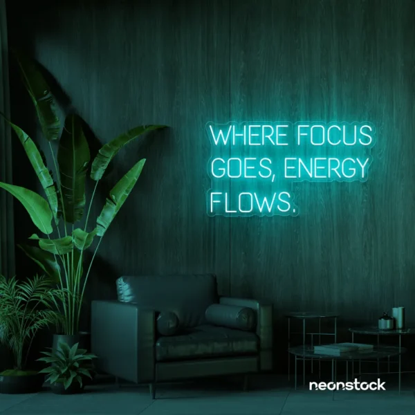 Where Focus Goes Energy Flows neon sign in mint green for productivity decor and creative inspiration.