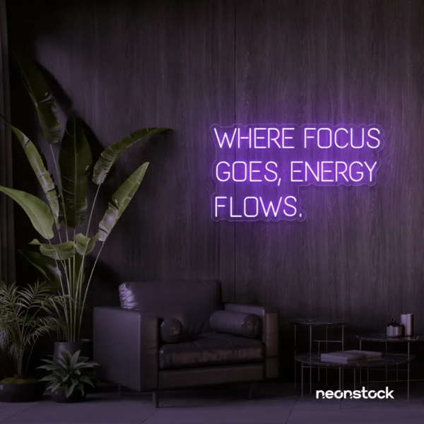 Where Focus Goes Energy Flows neon sign in purple for productivity decor and creative inspiration.