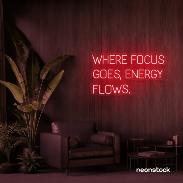 Where Focus Goes Energy Flows neon sign in red for productivity decor and creative inspiration.