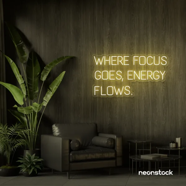 Where Focus Goes Energy Flows neon sign in warm white for productivity decor and creative inspiration.