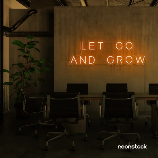 Let Go and Grow neon sign in orange for growth mindset decor, wellness rooms, and modern inspiration walls.