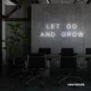 Let Go and Grow neon sign in white for growth mindset decor, wellness rooms, and modern inspiration walls.