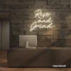 Rise and Grind neon sign in neutral white for gym walls, hustle rooms, and motivational office decor.