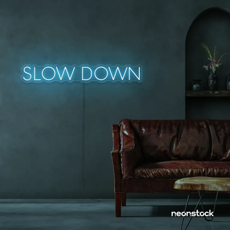 Slow Down neon sign in baby pink for relaxation spaces, wellness decor, and mindful interiors.