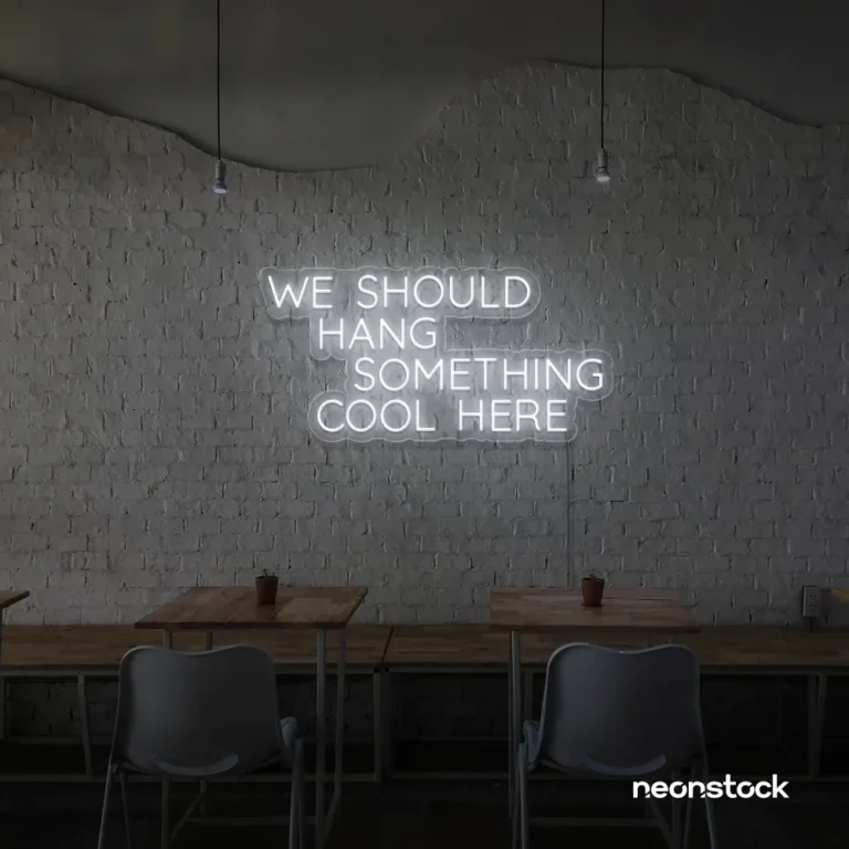Neon sign text 'We should hang something cool here' in white for wall art and home decor